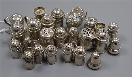 Twenty five assorted miniature Victorian and later silver peppers, including acorn, caster and churn examples and a pair